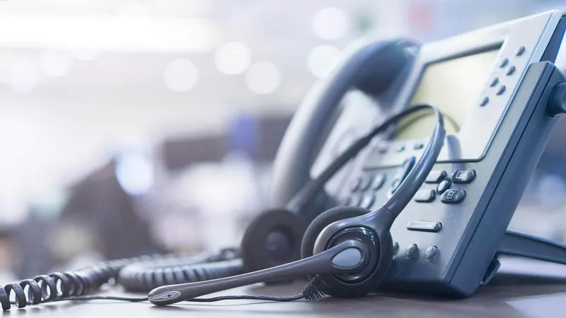 Office desk phone with a headset
