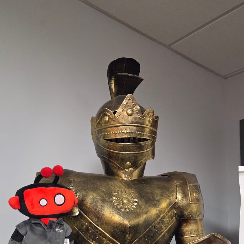 The office’s gold knight statue next to a plush Sierra robot mascot