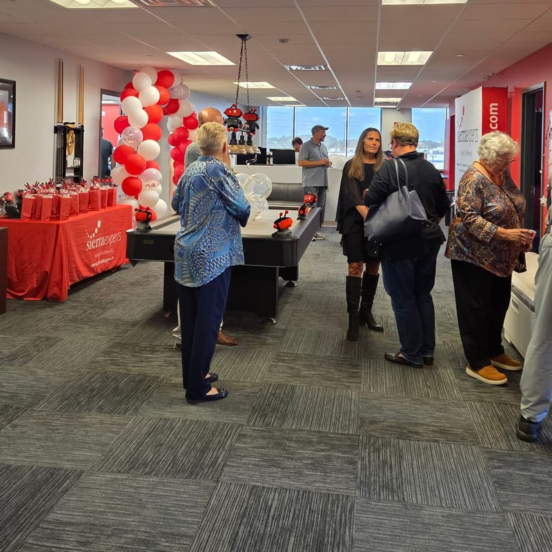 Guests mingling across the Sierra Experts office during the anniversary open house