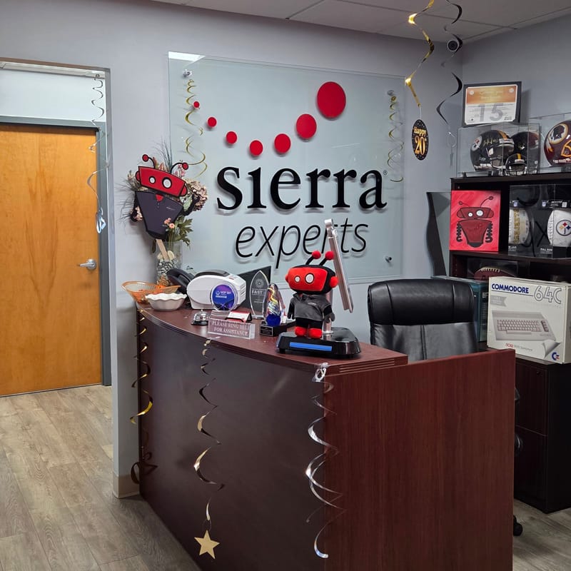 Sierra Experts reception desk and logo wall decorated for the anniversary