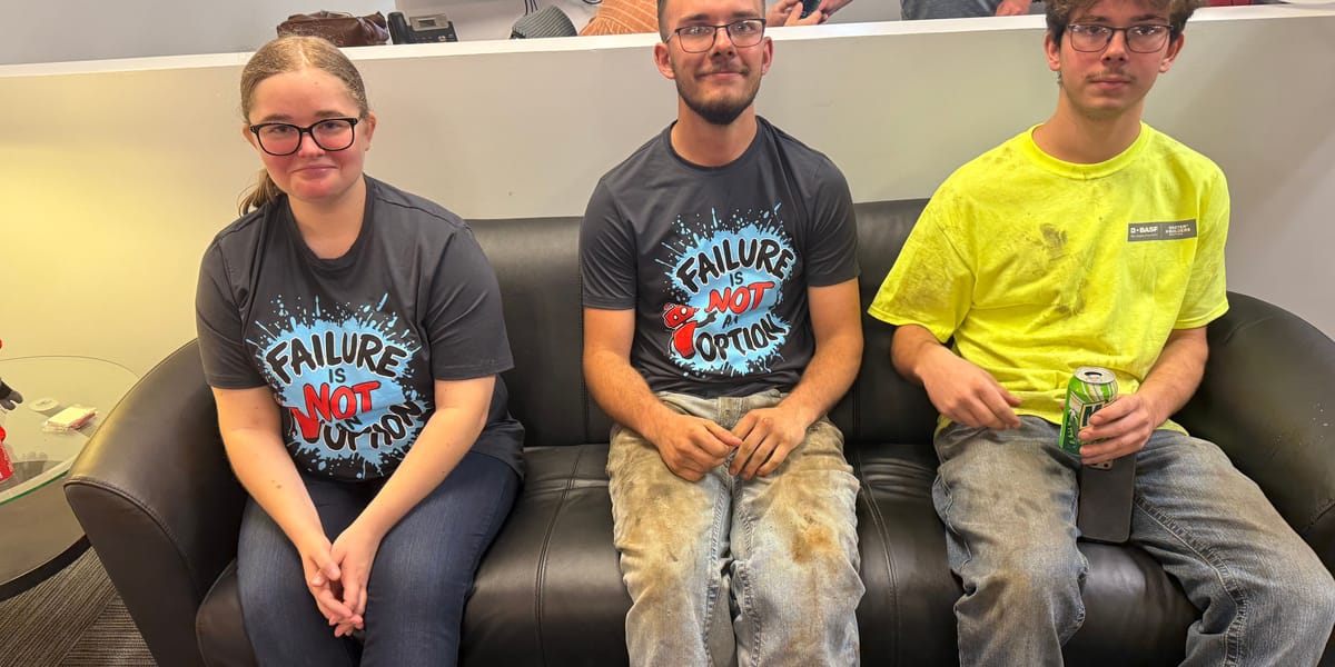 Three team members in Sierra t-shirts relaxing on the office couch