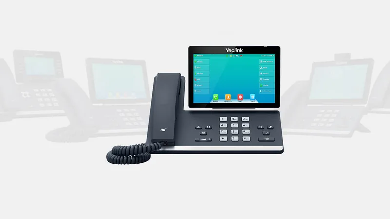 Yealink T57W business phone, with other Yealink T5 series phones behind it