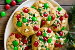 a pile of cookies with chocolate chips, m and m's, and sprinkles