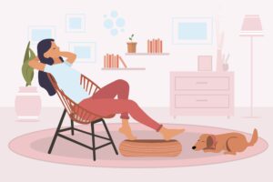 a woman relaxing in a chair with a brown dog at her feet